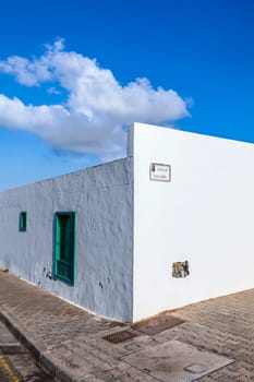facade of mediterranean house with closed shutterblinds at midday