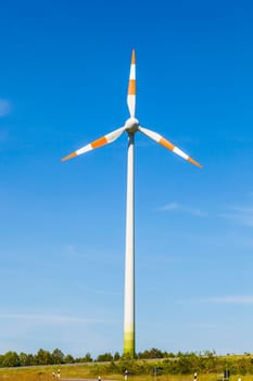 Windmill gathers energy from the summer breeze.