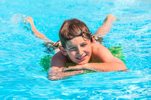 cute boy swimming in the pool