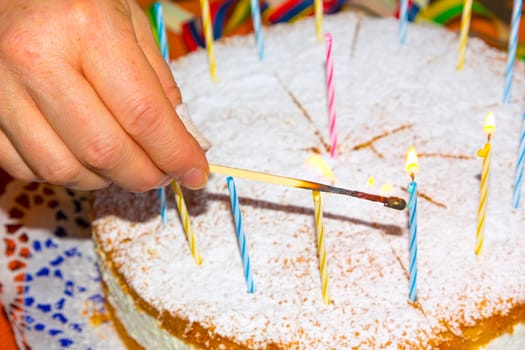 lighting the birthday candles on the cake