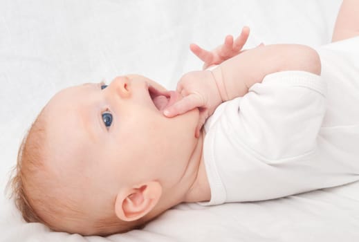 Newborn Baby Lying on Back on White Background
