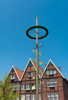 traditional bavarian maypole in Munster, Germany. In Germany and Austria the maypole (or Maibaum) is a tradition going back to the 16th century. It is a decorated tree or tree trunk that is usually erected either on 1 May  in Baden and Swabia - or on the