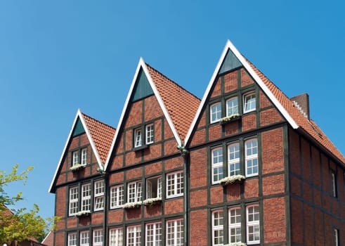 typical half-timbered German house with flower planters outside the windows