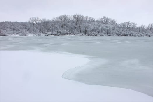 Fresh snowfall over a lake in northern Illinois on a cold winter day.