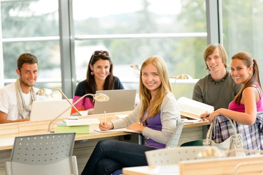 Student back to school in library study computer notes books