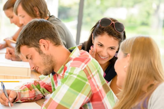 Pupils gossiping behind colleague's back in school class college teens