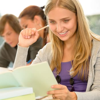 High-school student taking notes in library study academic campus teenager