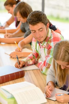 High-school student peeking at his colleague quiz teens academic young