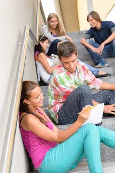 Students talking relaxing on school steps teens break smiling campus