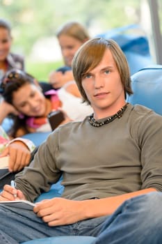 High-school students in study room reading writing close up young
