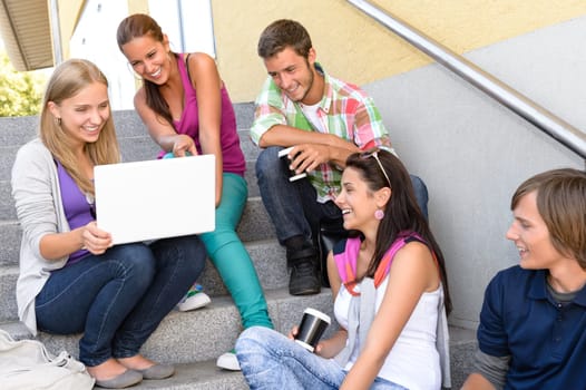 Students having fun with laptop school stairs teens college laughing