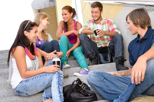 Students laughing on school stairs in break teens college relaxing