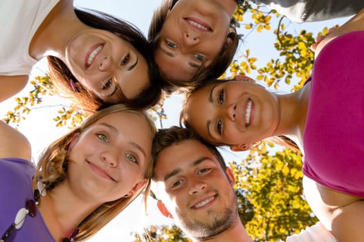 Teens in a circle smiling in park leisure students friends