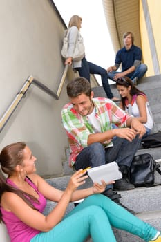 Students talking relaxing on school steps teens break smiling campus