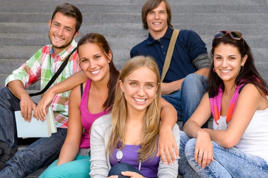 Students sitting on school stairs smiling teens campus college friends