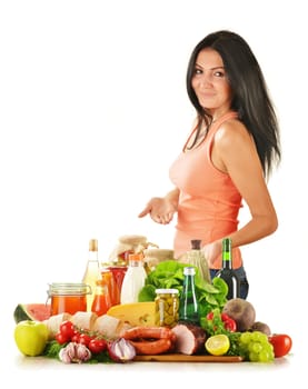 Young woman with variety of grocery products including vegetable, fruits, meat, dairy and wine