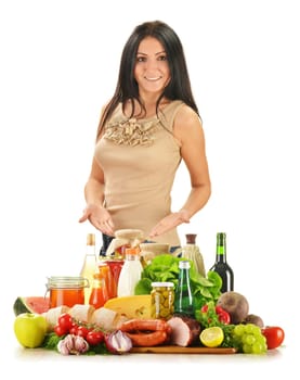 Young woman with variety of grocery products including vegetable, fruits, meat, dairy and wine
