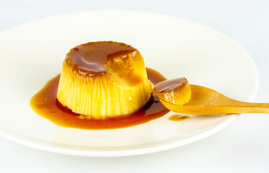 Delicious vanilla cream, egg custard with caramel sauce, and spoon