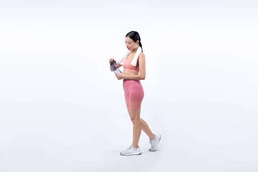 Athletic and sporty asian woman resting and drink water after intensive cardio workout training. Healthy exercising and fit body care lifestyle pursuit in studio shot isolated background. Vigorous