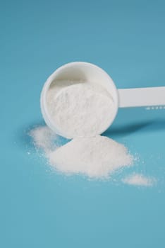 Close up of baby milk powder and spoon on tile background