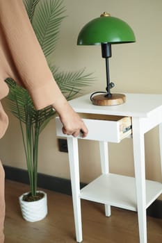 women hand open drawer wooden in cabinet.