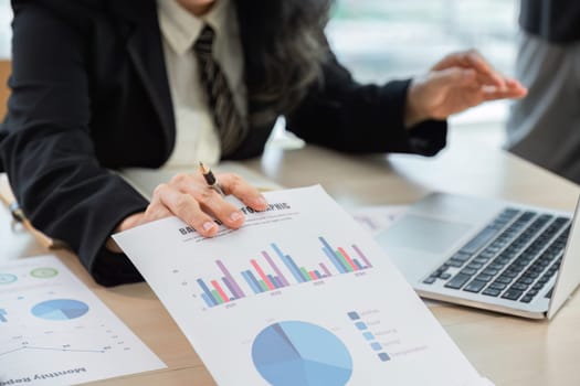 Business woman using laptop for do math finance on wooden desk in office and business working background, tax, accounting, statistics and analytic research concept.