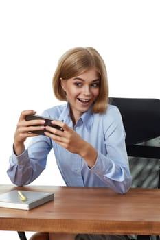 happy excited blonde business woman using phone and reading good news at in the office