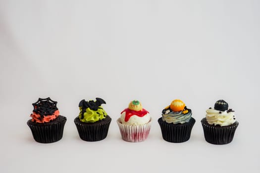 a set of horror halloween themed artsy cupcakes muffin isolated on white