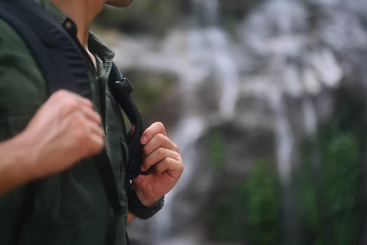 Male hiker with backpack trekking in forest and exploring nature. Travel, adventure and active life concept.