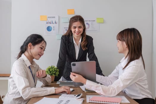 Business People Meeting using laptop computer,calculator,notebook,stock market chart paper for analysis Plans to improve quality next month. Conference Discussion Corporate Concept..