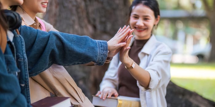 Student university friendship concept with classmate sitting together at campus college park. Youth teenage and education.