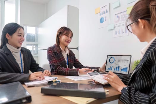 Business People Meeting using laptop computer,calculator,notebook,stock market chart paper for analysis Plans to improve quality next month. Conference Discussion Corporate Concept..