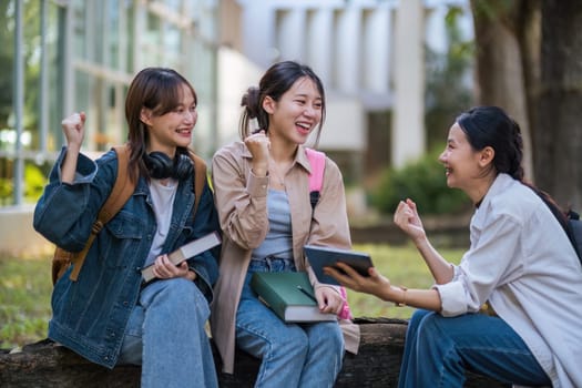 Student university friendship concept with classmate sitting together at campus college park. Youth teenage and education.