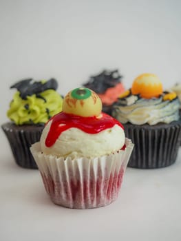 a set of horror halloween themed artsy cupcakes muffin isolated on white