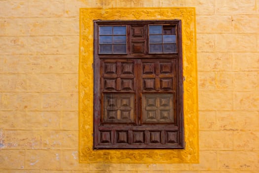 La Orotava wooden window in yellow wall Tenerife at Canary Islands