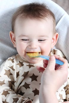 Baby boy eating vegetable mash