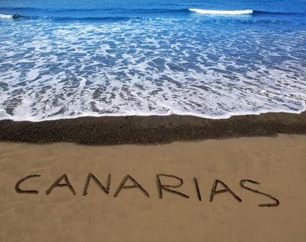 Brown beach sand with written word Canarias in Canary islands