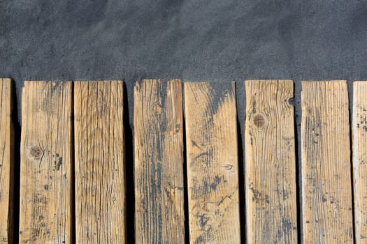 Black beach sand and wooden floor in volcanic Canary Islands
