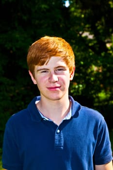 portrait of attractive happy smiling boy in the garden