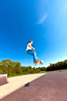 boy jumping with his scooter
