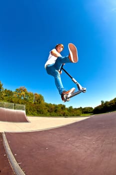 boy jumping with his scooter