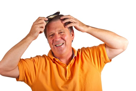 attractive man combing his hair in the studio