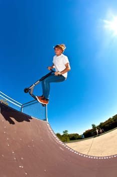 boy jumping with his scooter
