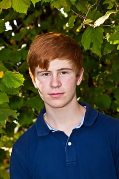 portrait of attractive happy smiling boy in the garden