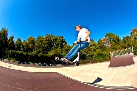 boy jumping with his scooter