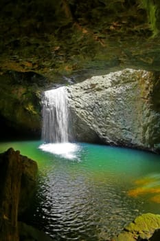 The waterfall at Natural Arch in Springbrook National Park in the Gold Coast hinterland in Queensland Australia.