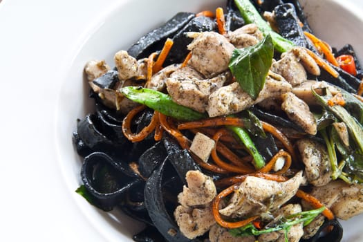 Stir in spaghetti, black lines. A spicy. thai style.