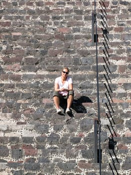 Young woman sitting on a stone staircase