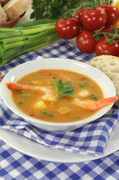 a bowl of bouillabaisse with prawns and mussels