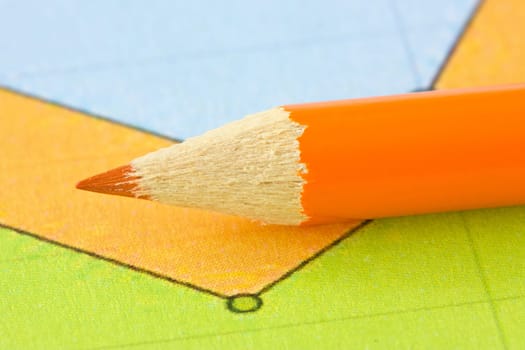 orange pencil on the colorful paper background